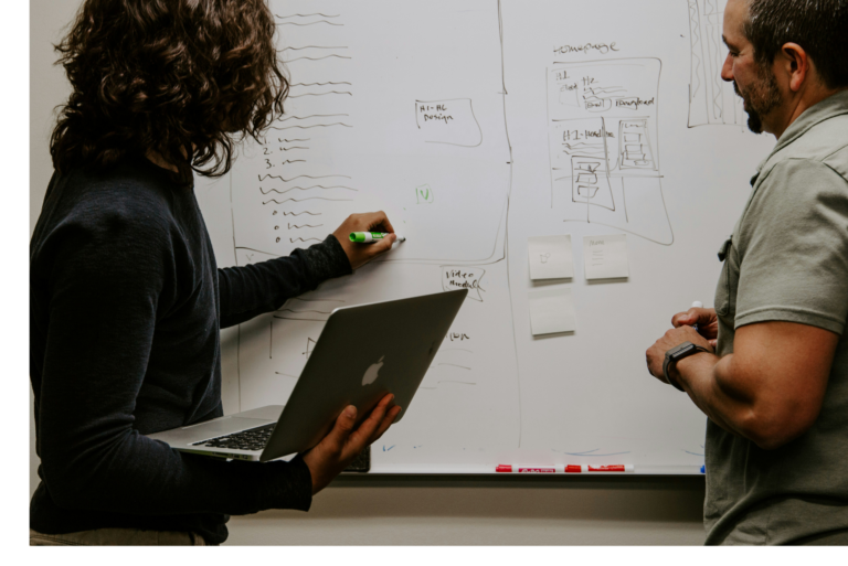 Professionals working on whiteboard